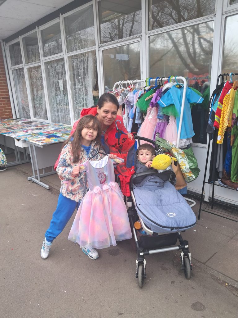 Handout free books and costumes for children at Gratitude Hub Food bank